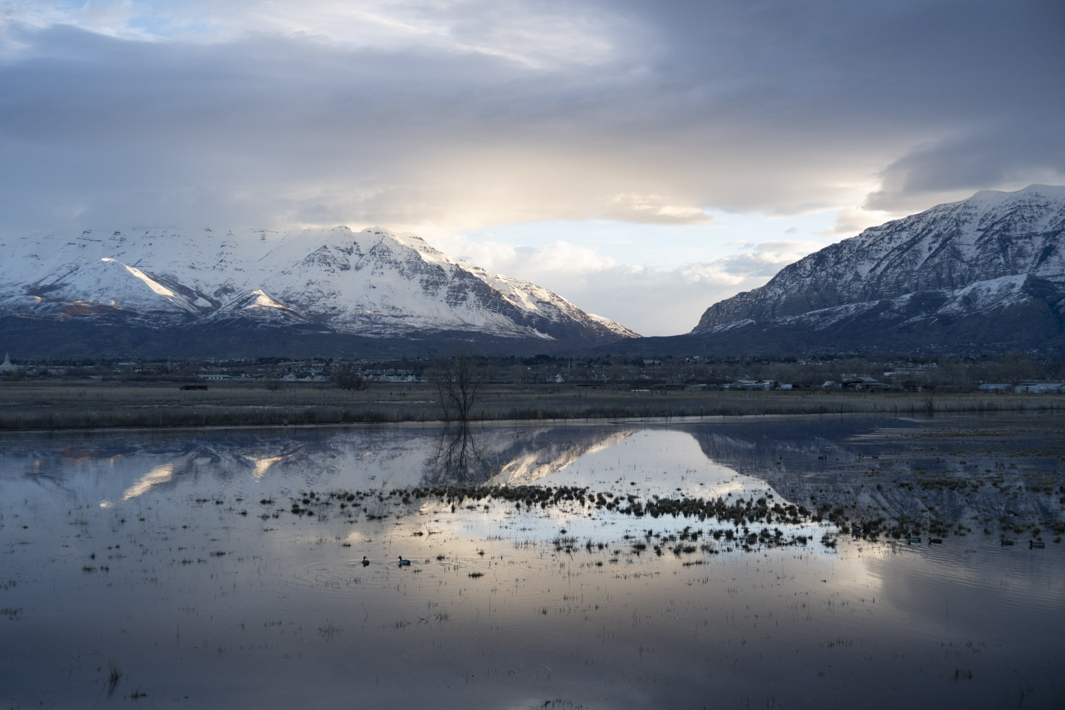 The snowy moutains catch late morning sun on a cloudy day